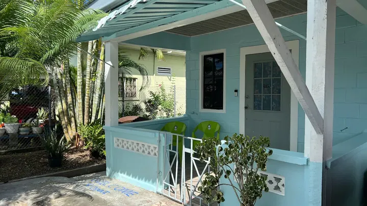A view of the cottage porch and garden from the side.